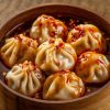 a-bowl-filled-with-golden-brown-dumplings-that-appear-to-be-coated-in-a-glossy-sauce[1]